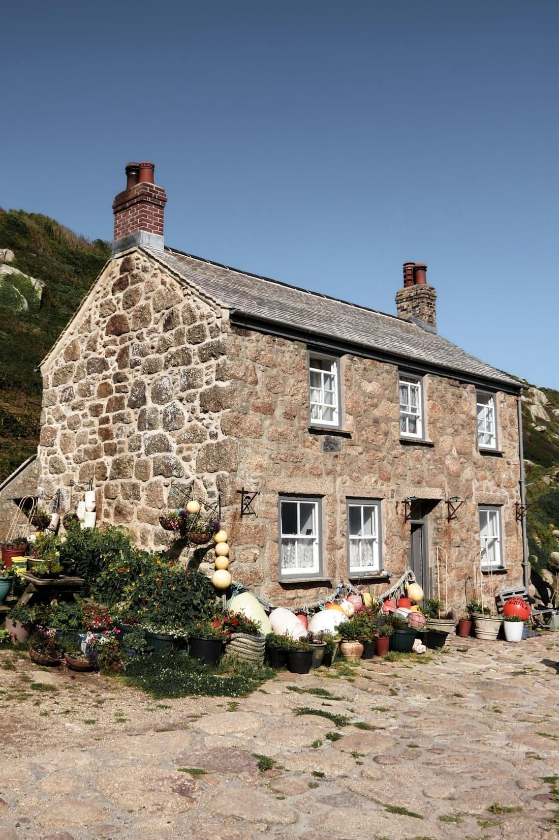 Applying lime render to a stone cottage wall